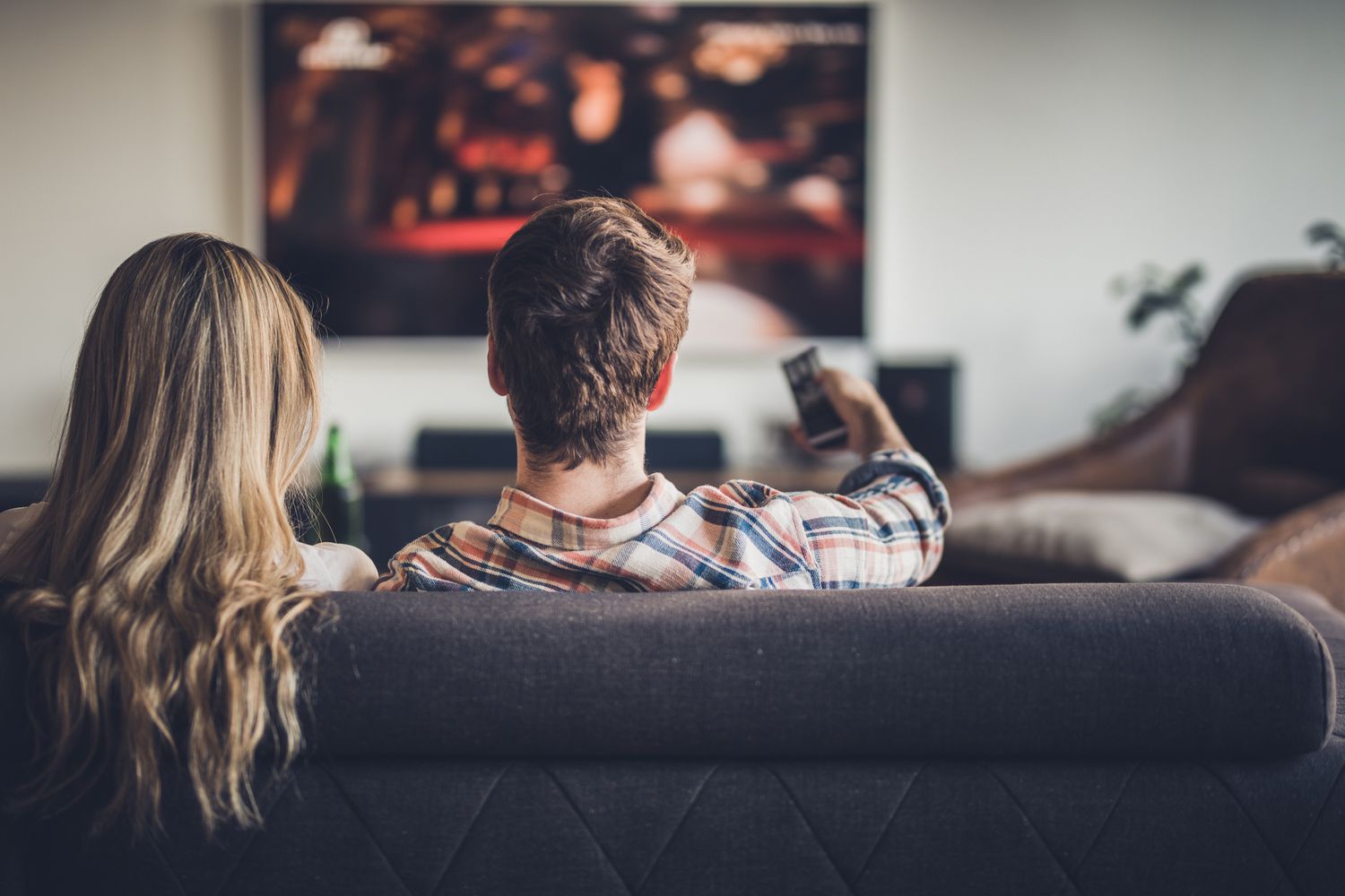 rear view of a couple watching tv while relaxing on the sofa at home 1132715308 84cec9878a8d4f2f98706c3d9953d487